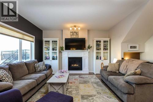 711 Moonlight Crescent W, Lethbridge, AB - Indoor Photo Showing Living Room With Fireplace
