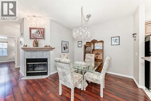 Dining room and fireplace - 1906 Patterson View Sw, Calgary, AB - Indoor Photo Showing Dining Room With Fireplace