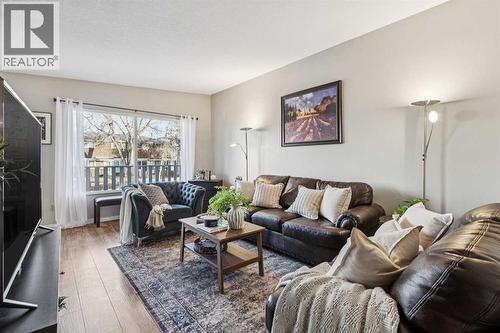Living room with access to front balcony - 23 Dovercliffe Way Se, Calgary, AB - Indoor Photo Showing Living Room