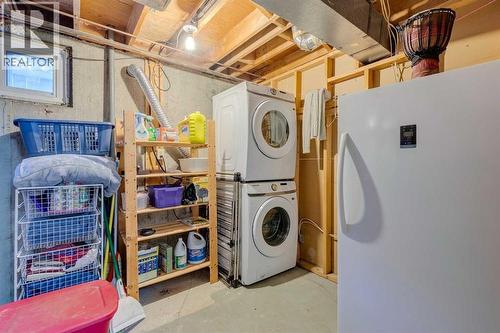 Laundry and storage room in the basement - 23 Dovercliffe Way Se, Calgary, AB - Indoor Photo Showing Laundry Room