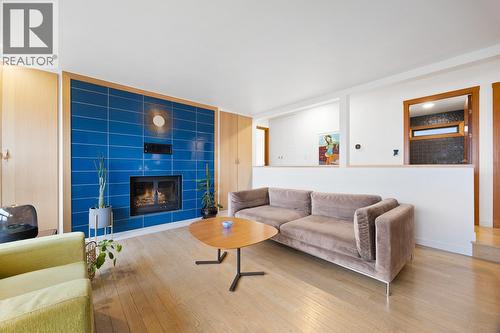 Stylish living room on the upper level with lake views - 1632 Griffiths Place, West Kelowna, BC - Indoor Photo Showing Living Room With Fireplace