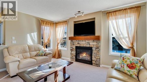 157 Bridleridge View Sw, Calgary, AB - Indoor Photo Showing Living Room With Fireplace