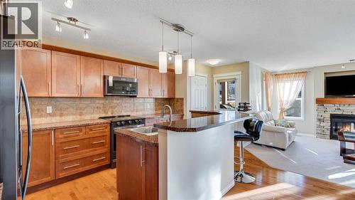 157 Bridleridge View Sw, Calgary, AB - Indoor Photo Showing Kitchen With Fireplace
