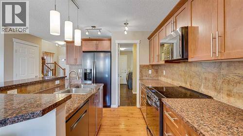 157 Bridleridge View Sw, Calgary, AB - Indoor Photo Showing Kitchen With Double Sink With Upgraded Kitchen