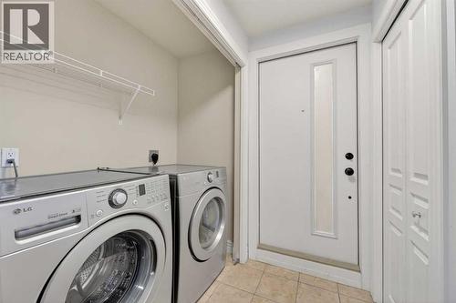 211, 25 Glamis Green Sw, Calgary, AB - Indoor Photo Showing Laundry Room