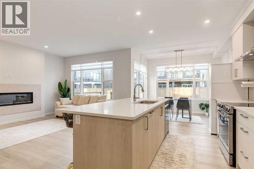 29 Marmot Passage Nw, Calgary, AB - Indoor Photo Showing Kitchen With Fireplace With Upgraded Kitchen