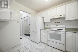 Kitchen With Tile Floor & Appliances - 