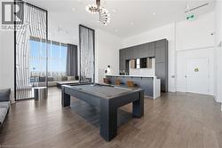 Rec room with pool table, a towering ceiling, - 