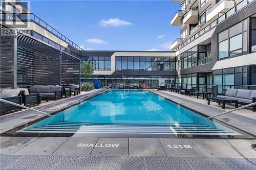 Resort style pool with an outdoor hangout area and a patio - 297 Oak Walk Drive Unit# 2407, Oakville, ON - Outdoor With In Ground Pool