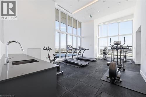 Exercise room with a high ceiling - 297 Oak Walk Drive Unit# 2407, Oakville, ON - Indoor Photo Showing Gym Room