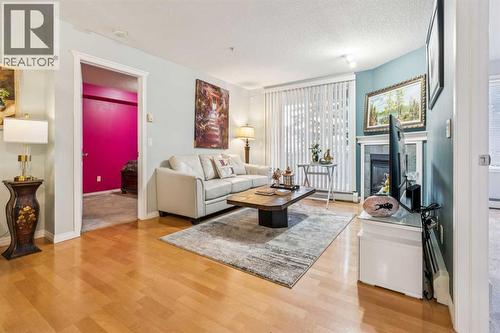 105, 15320 Bannister Road Se, Calgary, AB - Indoor Photo Showing Living Room With Fireplace