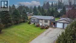 Split foyer home featuring a front yard, driveway, and a garage - 