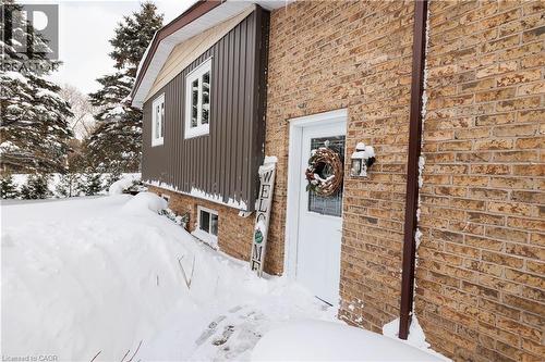 View of snow covered exterior with brick siding - 230 Saugeen Street, Grey Highlands, ON - Outdoor