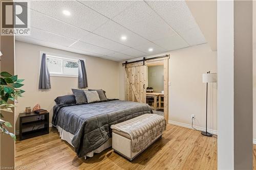 Bedroom with a barn door, light wood finished floors, a drop ceiling, and recessed lighting - 230 Saugeen Street, Grey Highlands, ON - Indoor Photo Showing Bedroom