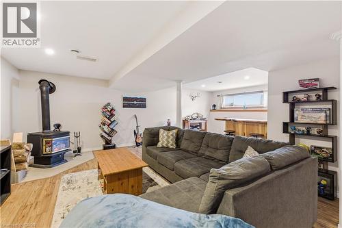 Living room with light wood-style floors, a wood stove, and recessed lighting - 230 Saugeen Street, Grey Highlands, ON - Indoor With Fireplace