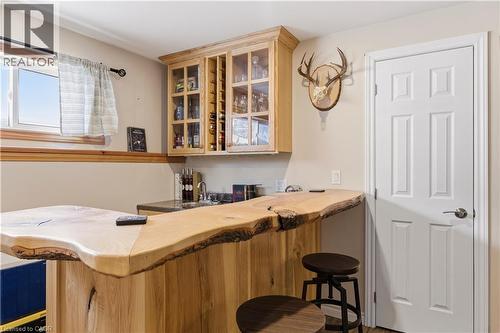 Indoor wet bar featuring glass insert cabinets and butcher block countertops - 230 Saugeen Street, Grey Highlands, ON - Indoor