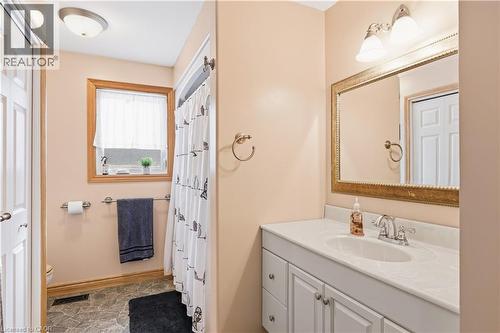 Bathroom with vanity, a shower with shower curtain, and stone finish floors - 230 Saugeen Street, Grey Highlands, ON - Indoor Photo Showing Bathroom