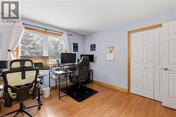 Home office with light wood-type flooring and baseboards - 
