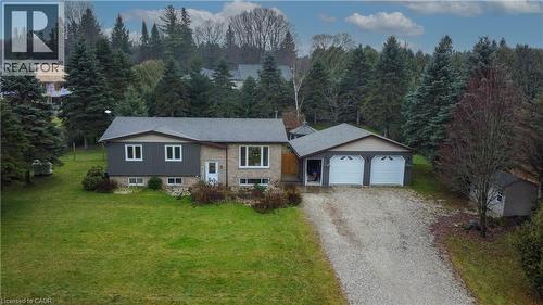 Raised ranch with gravel driveway, a front lawn, and a garage - 230 Saugeen Street, Grey Highlands, ON - Outdoor