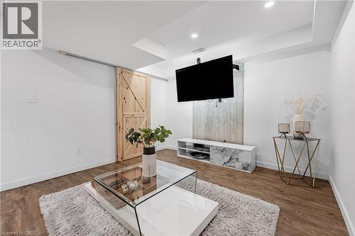 Bar area with light wood-style flooring and recessed lighting - 5056 New Street Unit# 21, Burlington, ON - Indoor