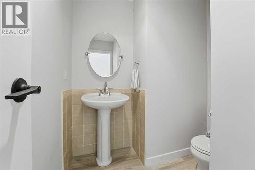 Main level 2 piece bathroom - 4 Pardue Close, Red Deer, AB - Indoor Photo Showing Bathroom