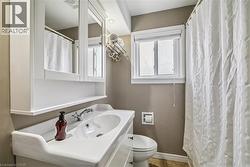 Full bath with a shower with shower curtain and vanity - 
