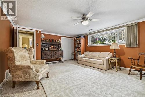 Living area with carpet floors, ornamental molding, ceiling fan, and a textured ceiling - 359 Pepper Drive, Burlington, ON - Indoor