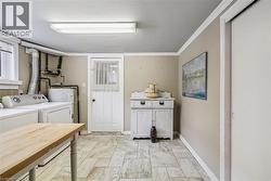 Washroom featuring separate washer and dryer and baseboards - 