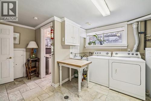 Washroom with cabinet space, washer and clothes dryer, ornamental molding, and water heater - 359 Pepper Drive, Burlington, ON - Indoor Photo Showing Laundry Room