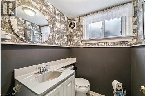 Half bath featuring vanity, wallpapered walls, and wainscoting - 359 Pepper Drive, Burlington, ON - Indoor Photo Showing Bathroom