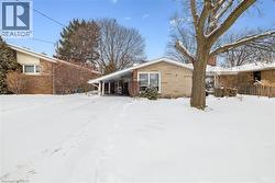 View of snow covered exterior featuring brick siding - 