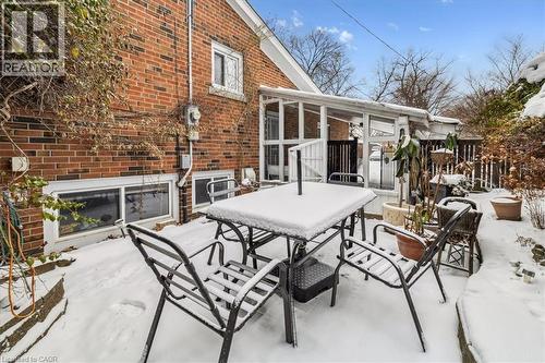 Snow covered patio with outdoor dining area and a sunroom - 359 Pepper Drive, Burlington, ON - Outdoor With Deck Patio Veranda