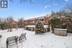 Snow covered property with brick siding - 