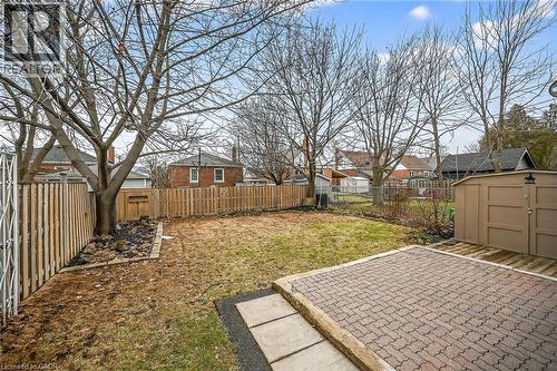 Fenced backyard featuring a residential view, a storage unit, and a patio area - 174 East 34Th Street, Hamilton, ON - Outdoor
