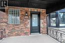 Doorway to property with brick siding and covered porch - 174 East 34Th Street, Hamilton, ON  - Outdoor 