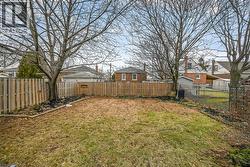 Fenced backyard featuring a residential view - 