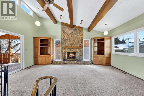 Family Room - Vaulted Open Beam  19'3" x 16'8" - 5315 Valiant Drive Nw, Calgary, AB - Indoor With Fireplace