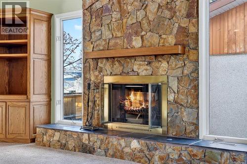 Natural Rock Wood Burning Fireplace with Log Lighter - 5315 Valiant Drive Nw, Calgary, AB - Indoor With Fireplace