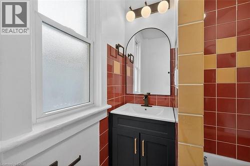 Bathroom featuring vanity and tile walls - 77 Barton Street E Unit# 2, Hamilton, ON - Indoor Photo Showing Bathroom