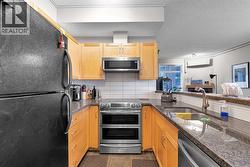 Kitchen with Breakfast Bar and Newer Stainless Steel Stove, Dishwasher, and Microwave - 