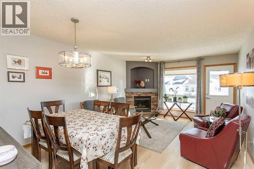409 Jenkins Drive, Red Deer, AB - Indoor Photo Showing Dining Room With Fireplace
