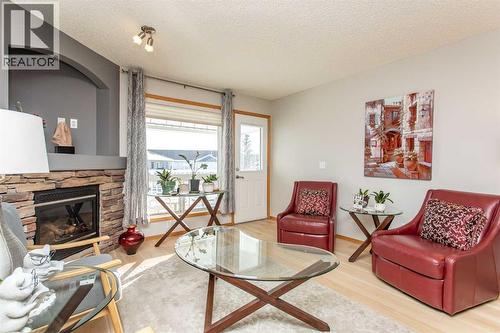 409 Jenkins Drive, Red Deer, AB - Indoor Photo Showing Living Room With Fireplace