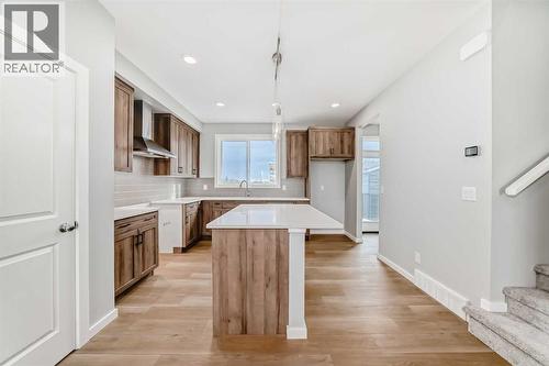 PLEASE NOTE: Photos are of a DIFFERENT Spec Home of the same model – fit and finish may differ. Interior selections and floorplans shown in photos - 85 Starling Boulevard Nw, Calgary, AB - Indoor Photo Showing Kitchen