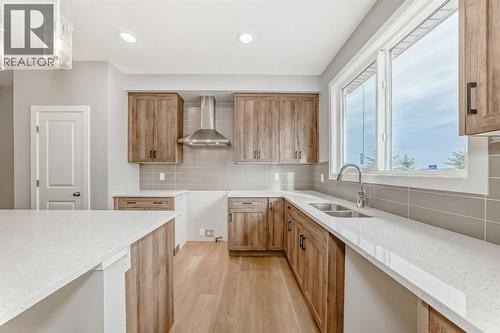 PLEASE NOTE: Photos are of a DIFFERENT Spec Home of the same model – fit and finish may differ. Interior selections and floorplans shown in photos - 85 Starling Boulevard Nw, Calgary, AB - Indoor Photo Showing Kitchen With Double Sink