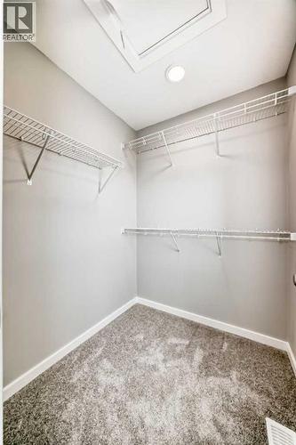 PLEASE NOTE: Photos are of a DIFFERENT Spec Home of the same model – fit and finish may differ. Interior selections and floorplans shown in photos - 85 Starling Boulevard Nw, Calgary, AB - Indoor With Storage