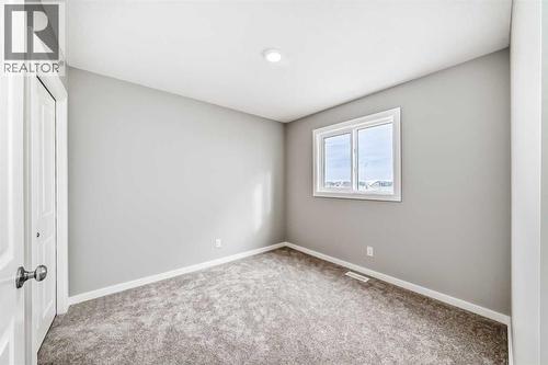 PLEASE NOTE: Photos are of a DIFFERENT Spec Home of the same model – fit and finish may differ. Interior selections and floorplans shown in photos - 85 Starling Boulevard Nw, Calgary, AB - Indoor Photo Showing Other Room