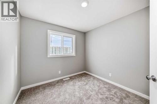 PLEASE NOTE: Photos are of a DIFFERENT Spec Home of the same model – fit and finish may differ. Interior selections and floorplans shown in photos - 85 Starling Boulevard Nw, Calgary, AB - Indoor Photo Showing Other Room