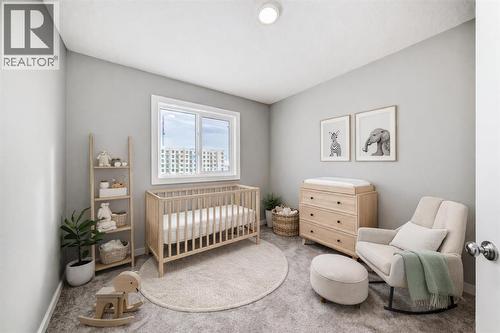 VIRTUALLY STAGED • PLEASE NOTE: Photos are of a DIFFERENT Spec Home of the same model – fit and finish may differ. Interior selections and floorplans shown in photos - 85 Starling Boulevard Nw, Calgary, AB - Indoor Photo Showing Bedroom