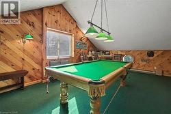 Game room featuring wooden walls, carpet floors, a textured ceiling, pool table, and baseboard heating - 