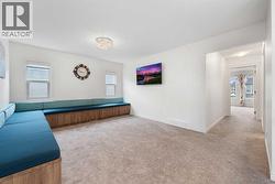 The spacious upper-level bonus room features custom seating.. - 